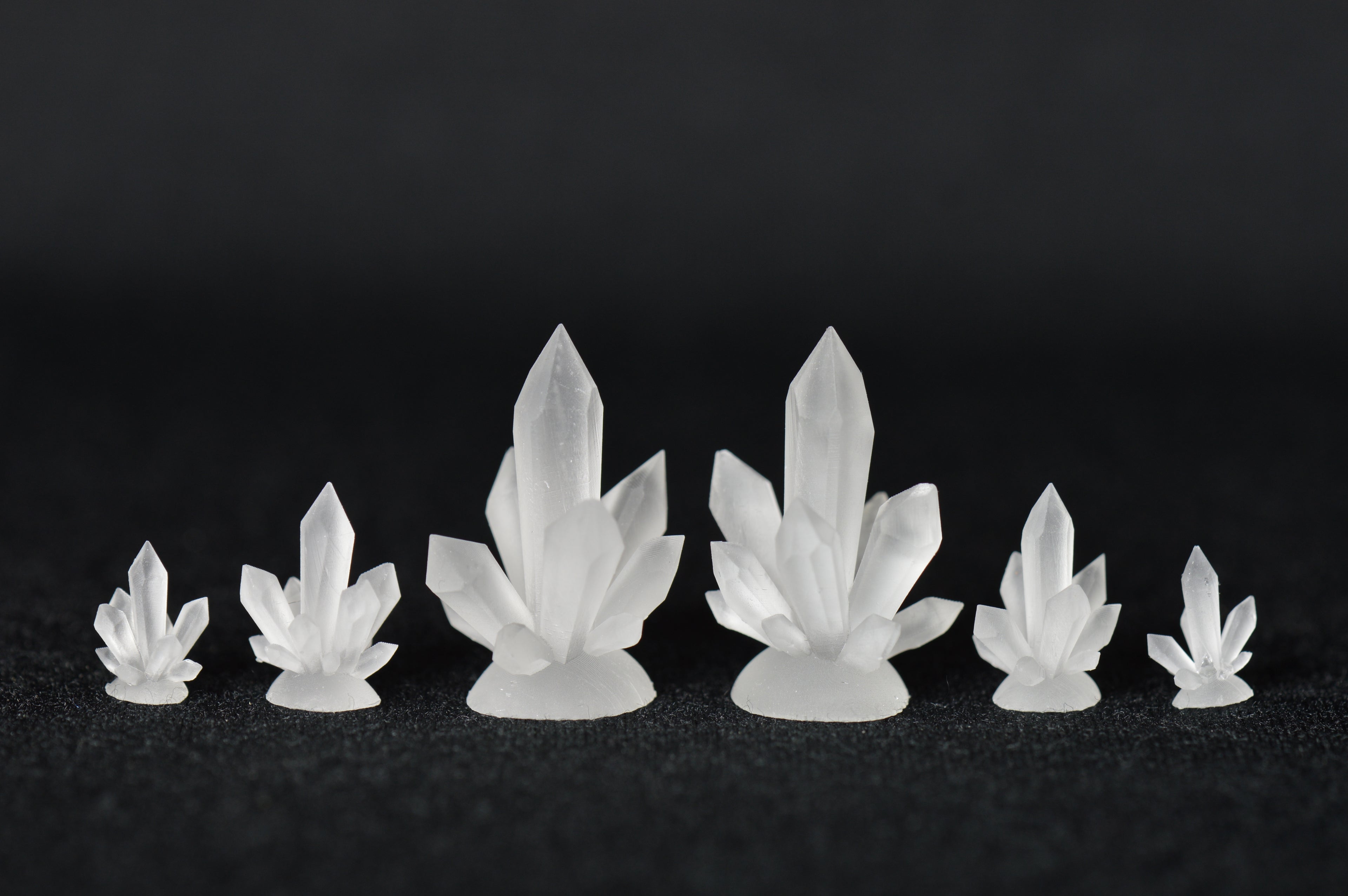 3D printed crystal dice inclusions on black background